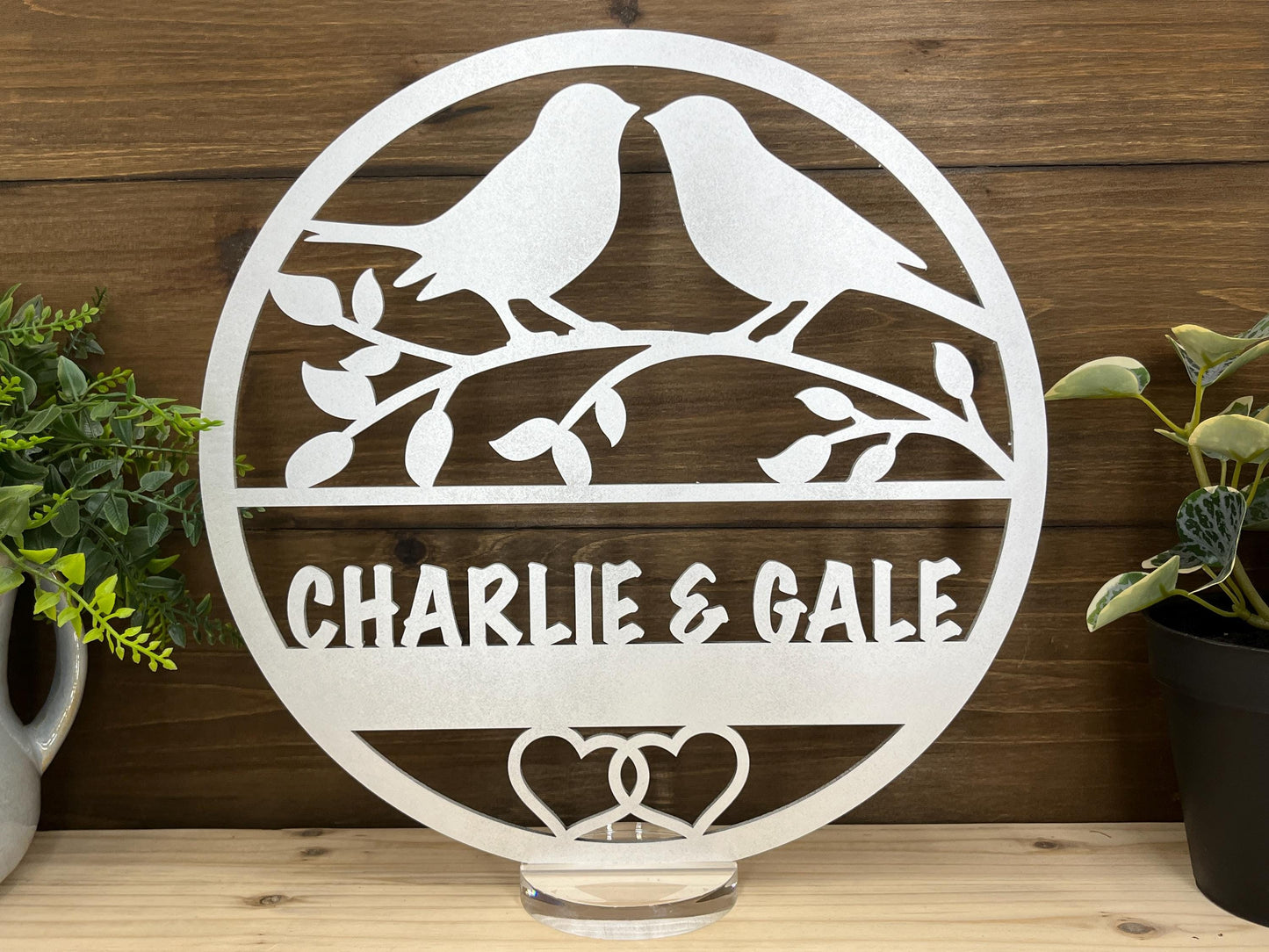 a couple of birds sitting on top of a metal sign