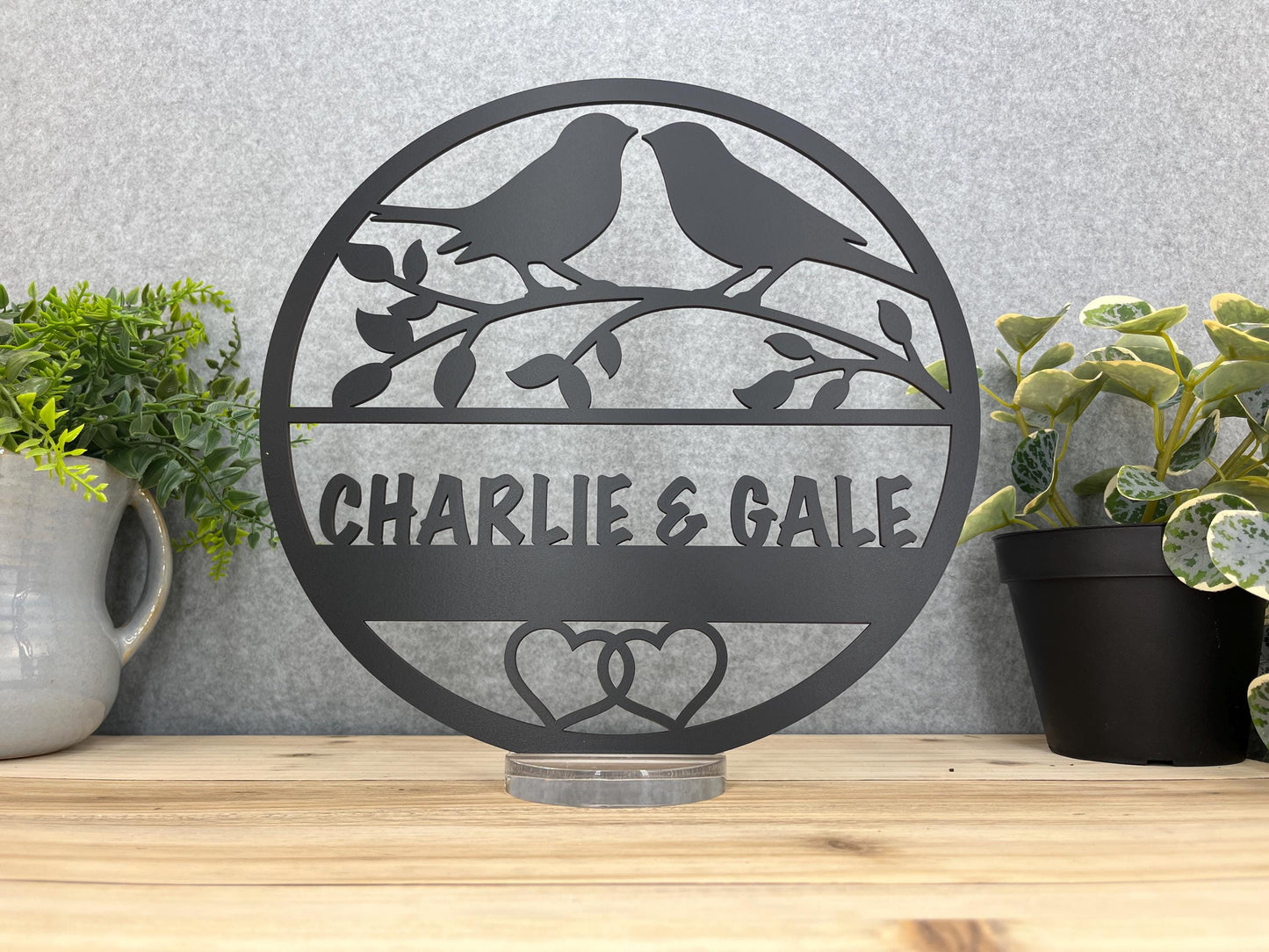 a couple of birds sitting on top of a metal sign