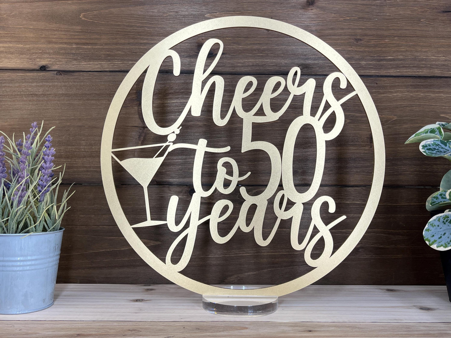 a metal sign that says cheers to 50 years