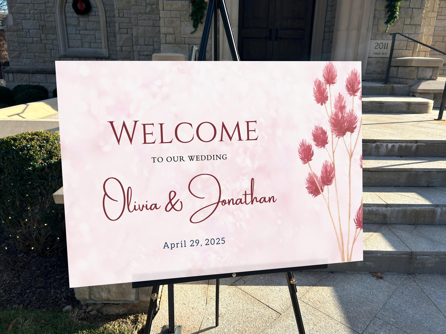 a welcome sign for a wedding in front of a church