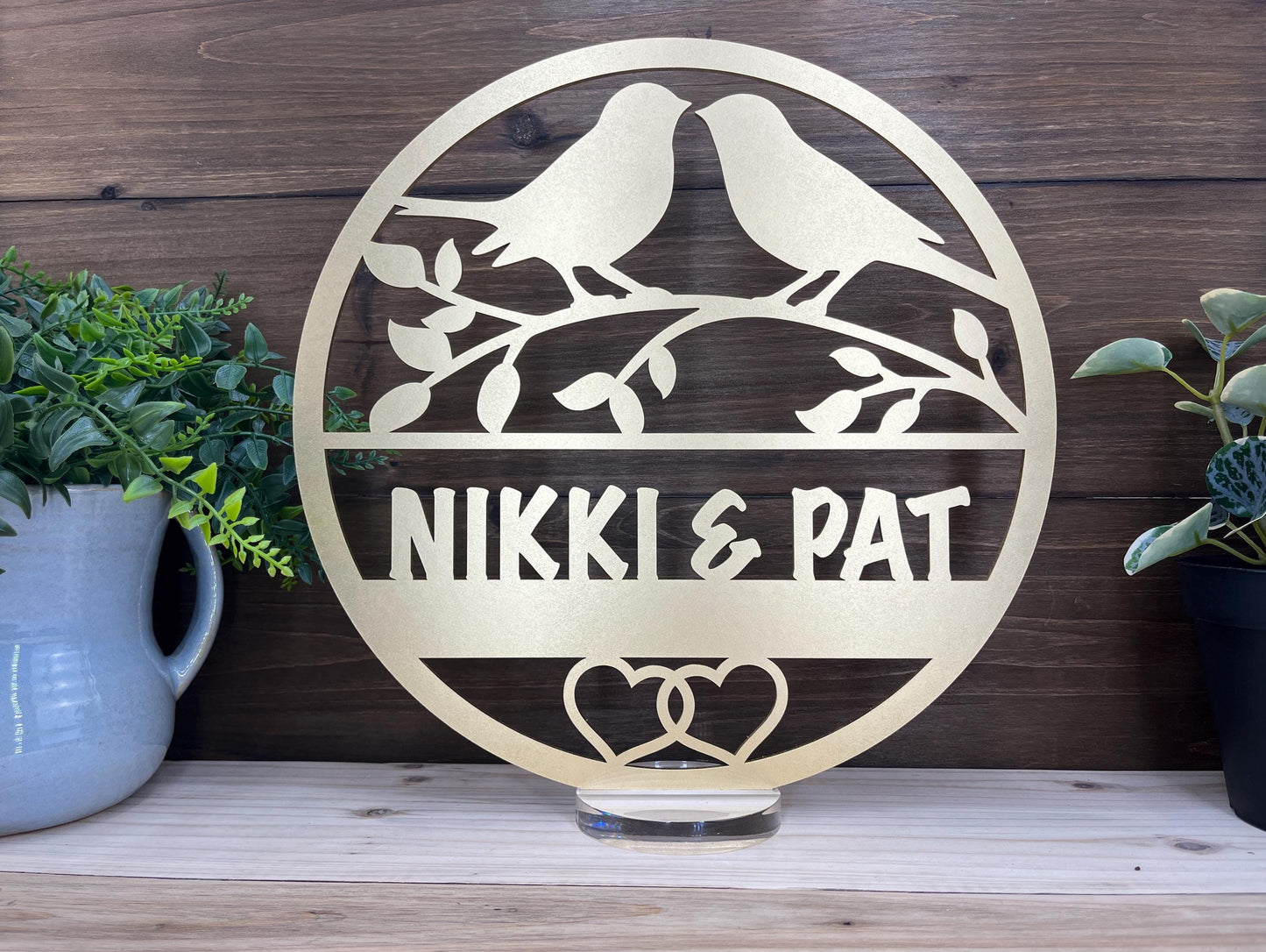 a couple of birds sitting on top of a metal sign