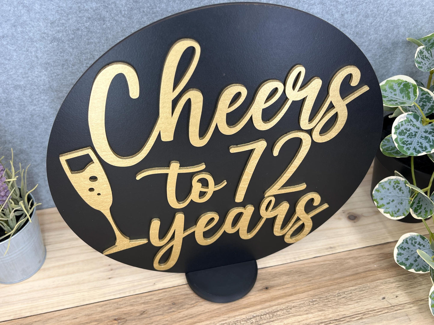 a sign that says cheers to seven years next to a potted plant