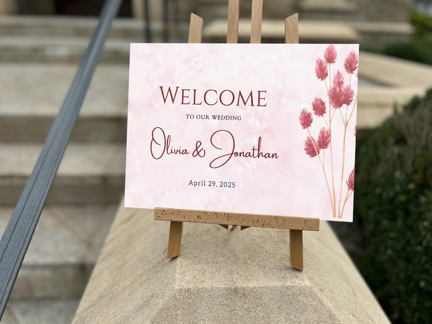 a welcome sign sitting on top of a cement block