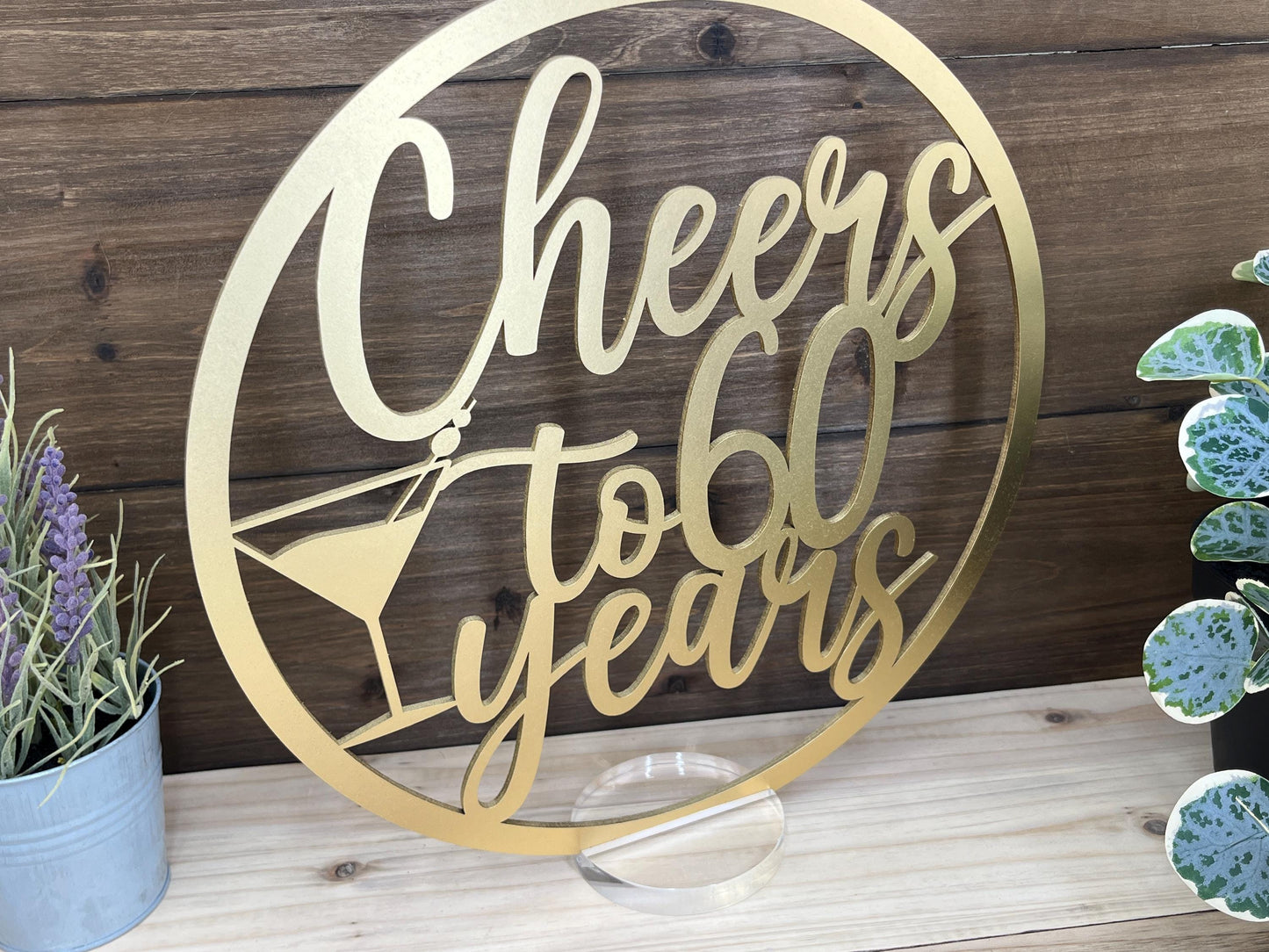 a metal sign that says cheers to 60 years