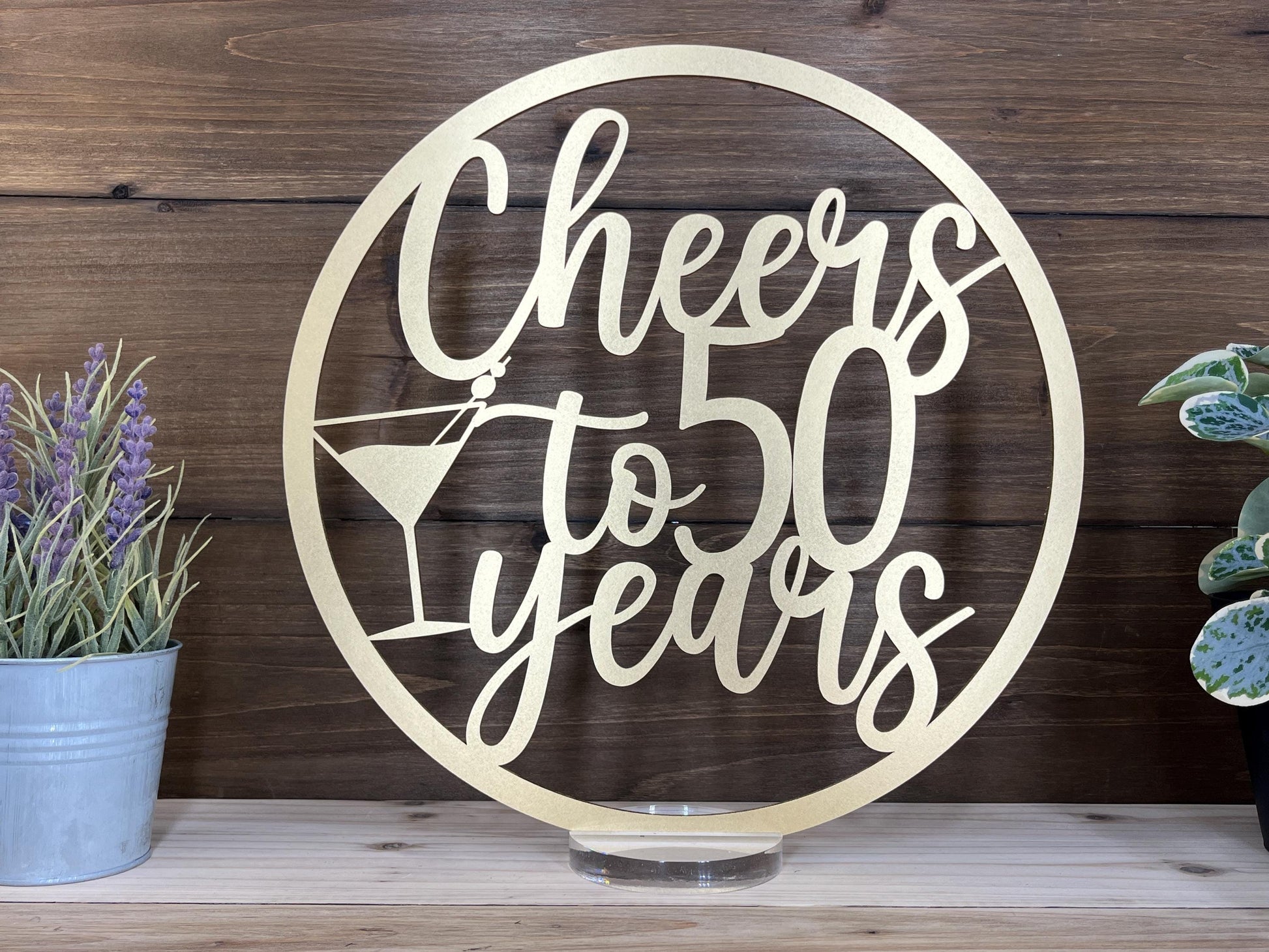 a metal sign that says cheers to 50 years
