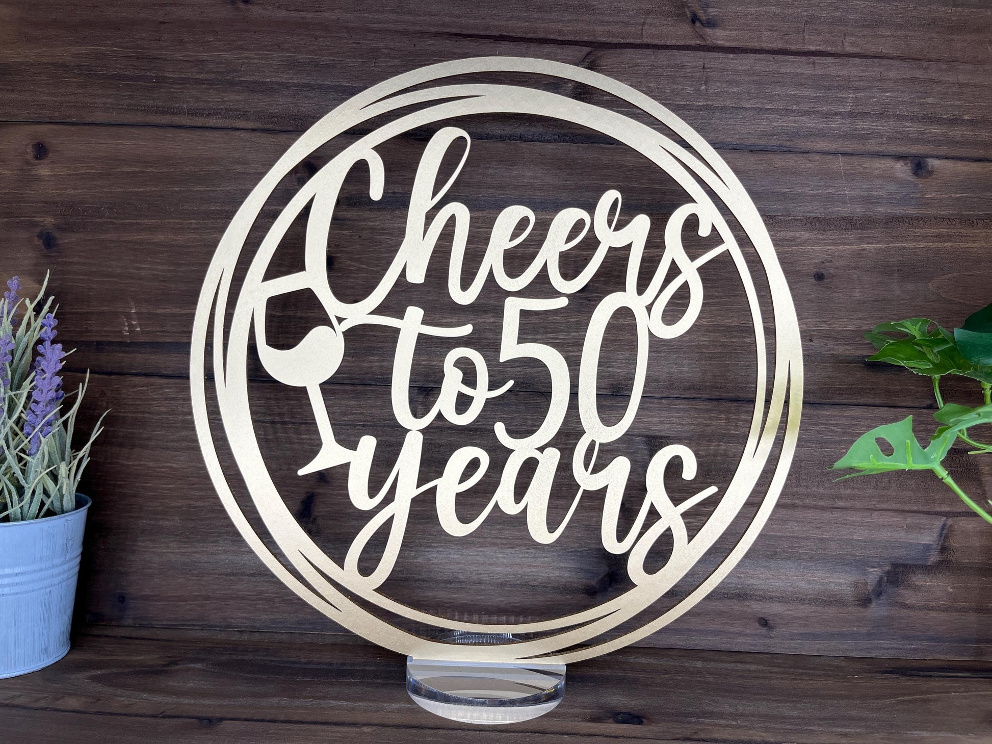 a metal sign that says cheers to 50 years