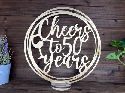 a metal sign that says cheers to 50 years