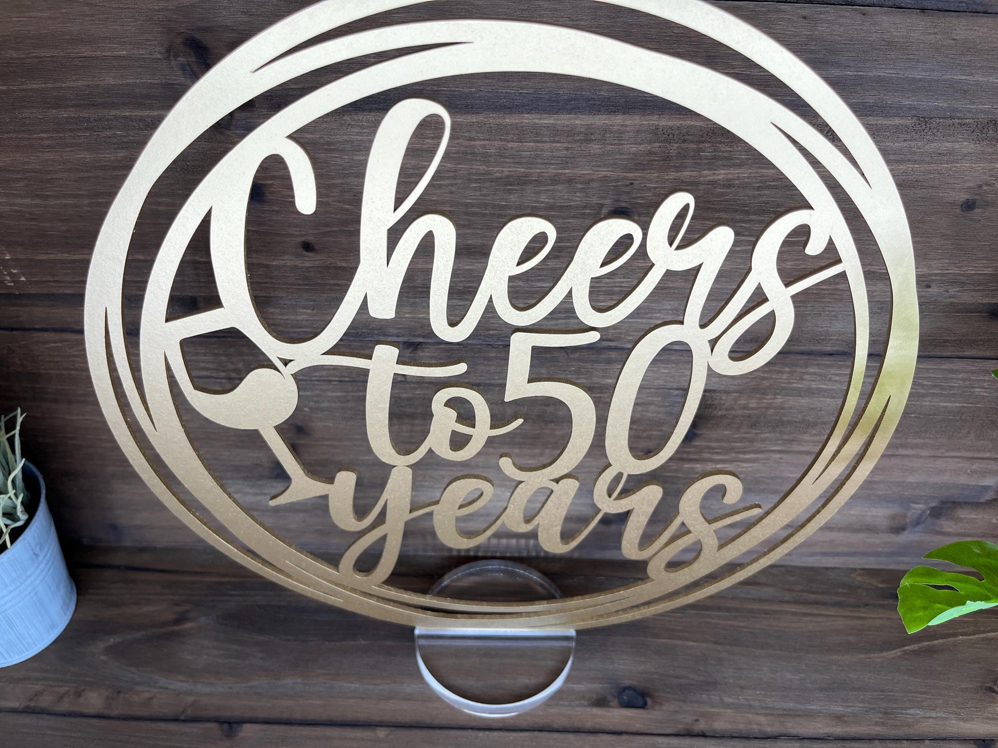 a metal sign that says cheers to 50 years