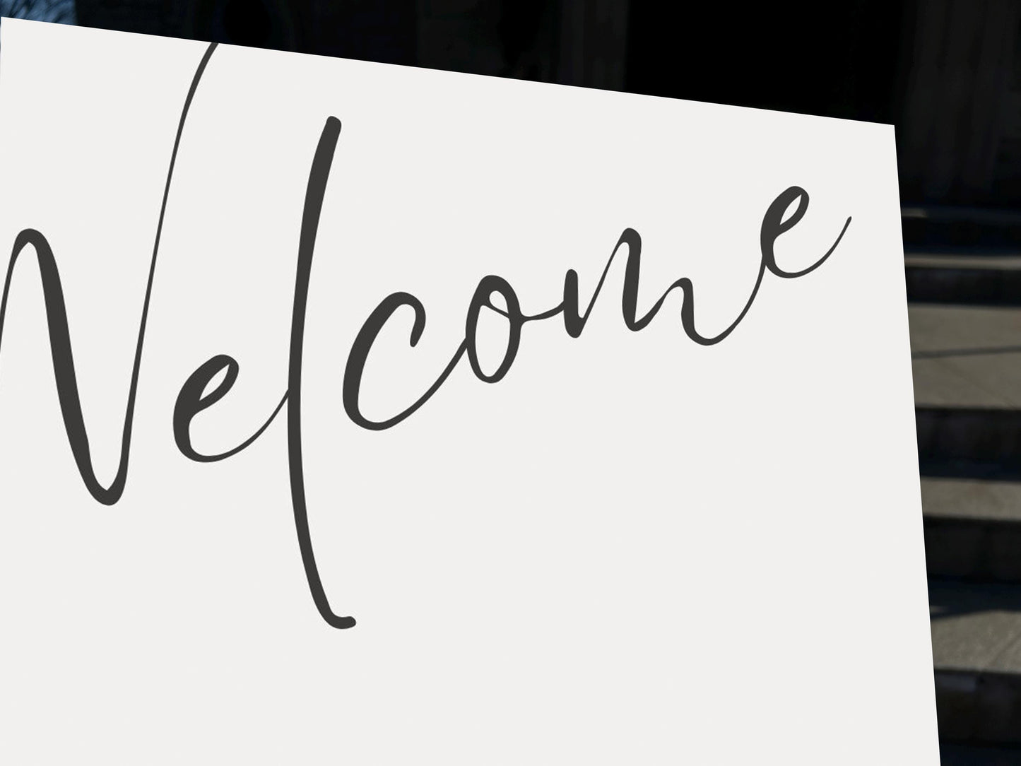 a white sign with the word welcome written on it