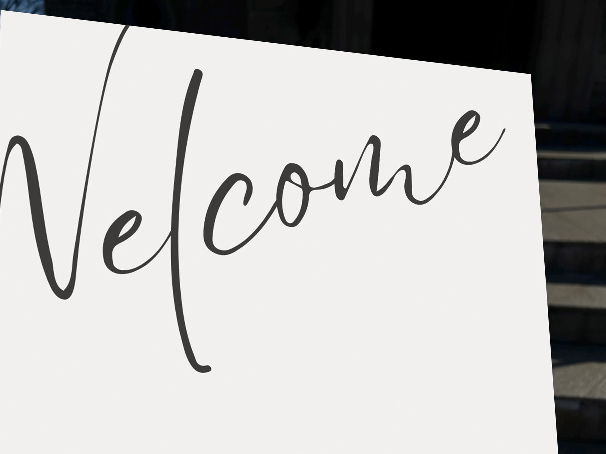 a white sign with the word welcome written on it