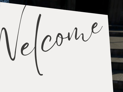 a white sign with the word welcome written on it