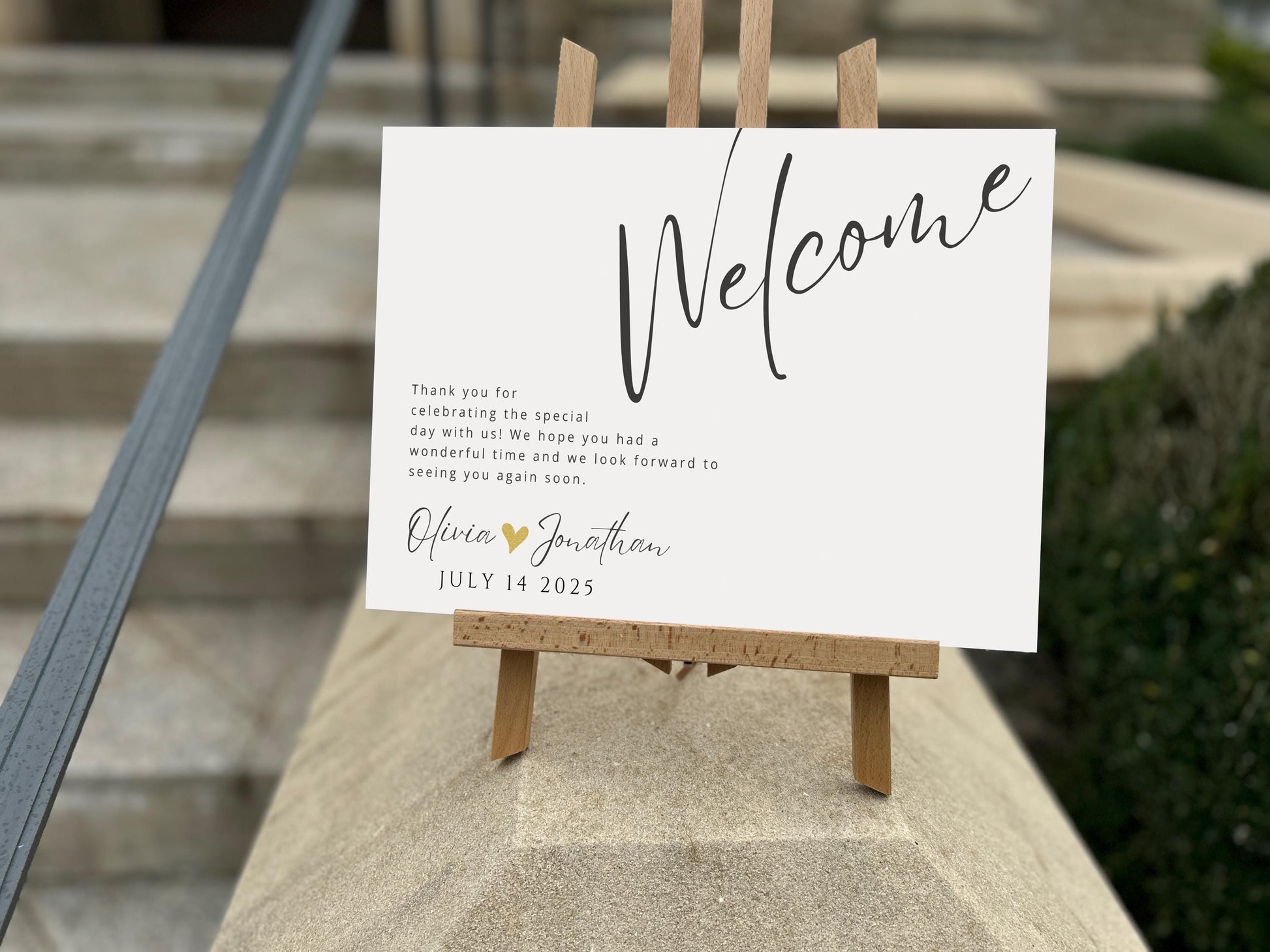 a welcome sign sitting on top of a cement block