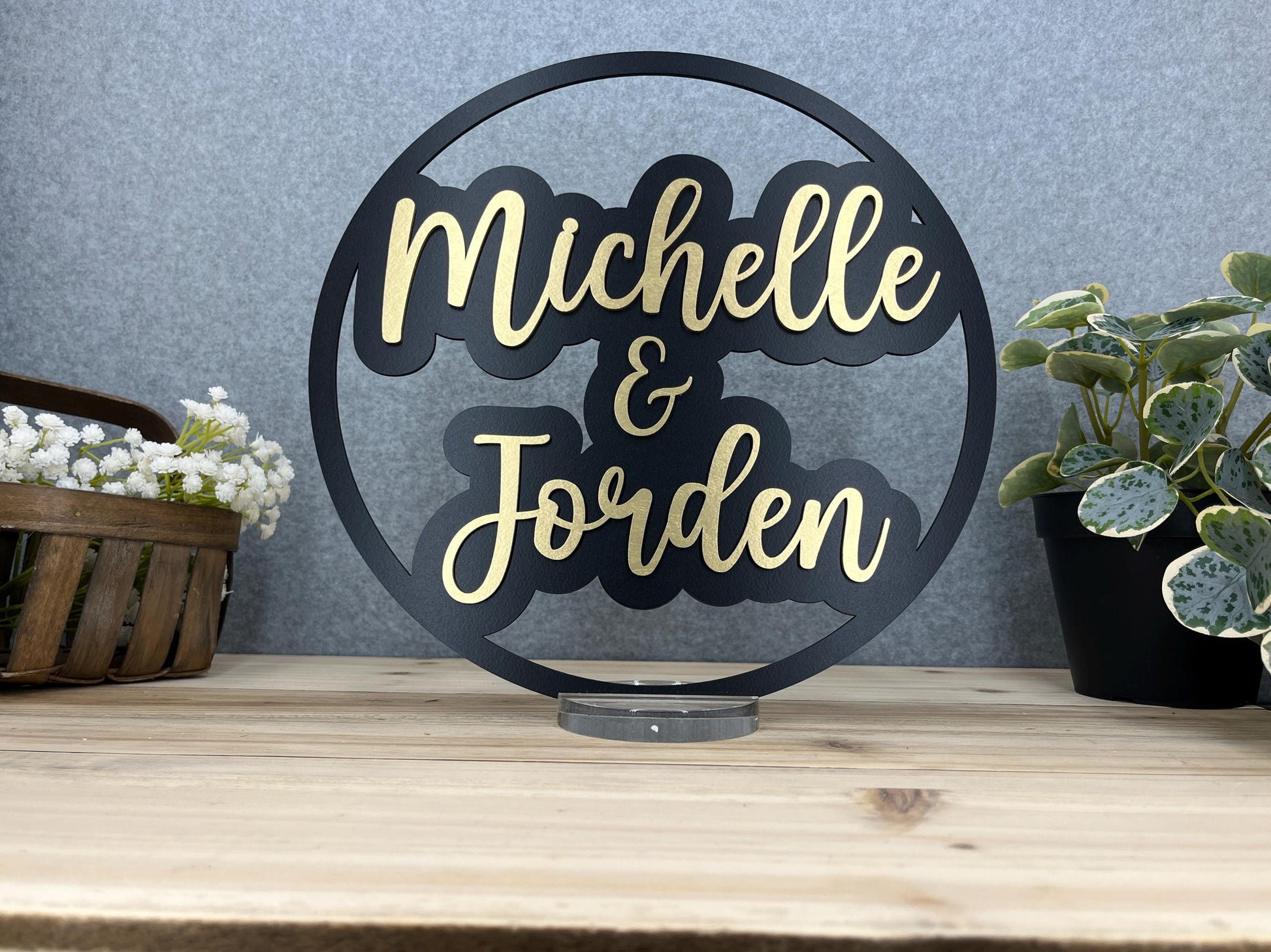 a couple of metal signs sitting on top of a wooden table