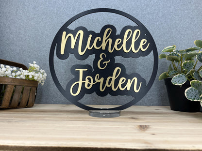 a couple of metal signs sitting on top of a wooden table