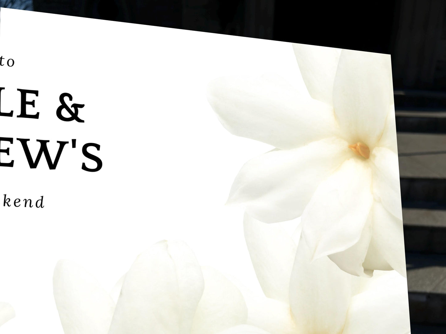a close up of a sign with flowers on it