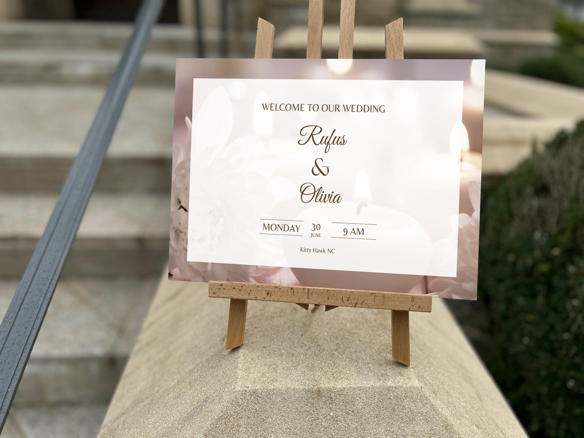 a wedding welcome card sitting on top of a wooden easel