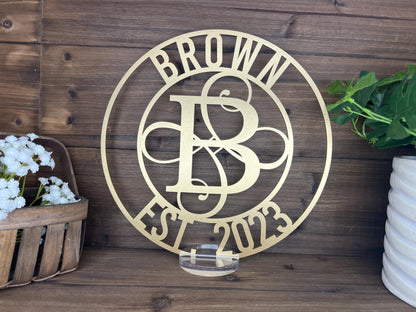 a metal sign on a wooden wall next to a potted plant