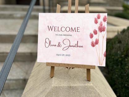 a welcome sign sitting on top of a cement block