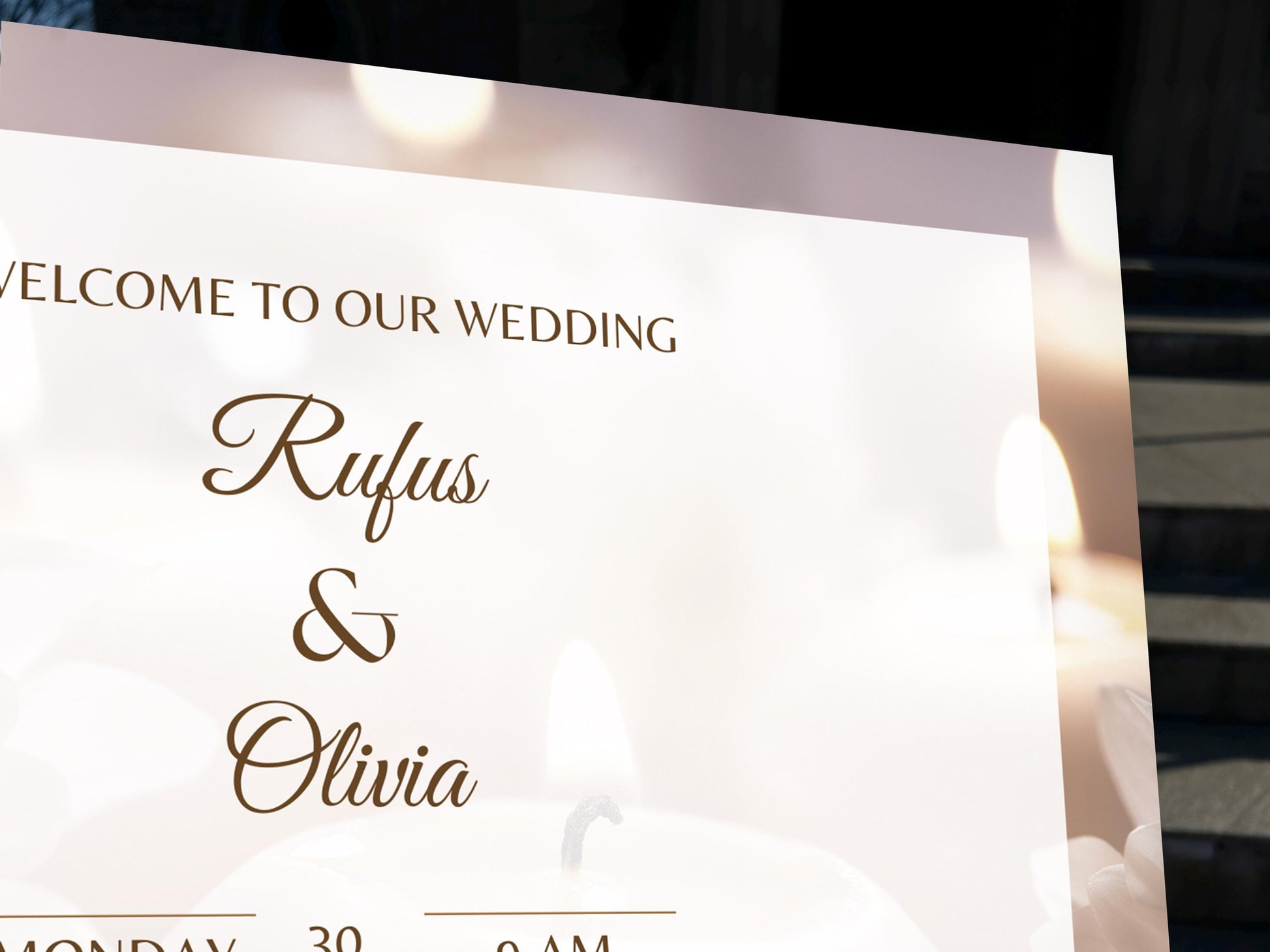 a welcome sign for a wedding with candles in the background